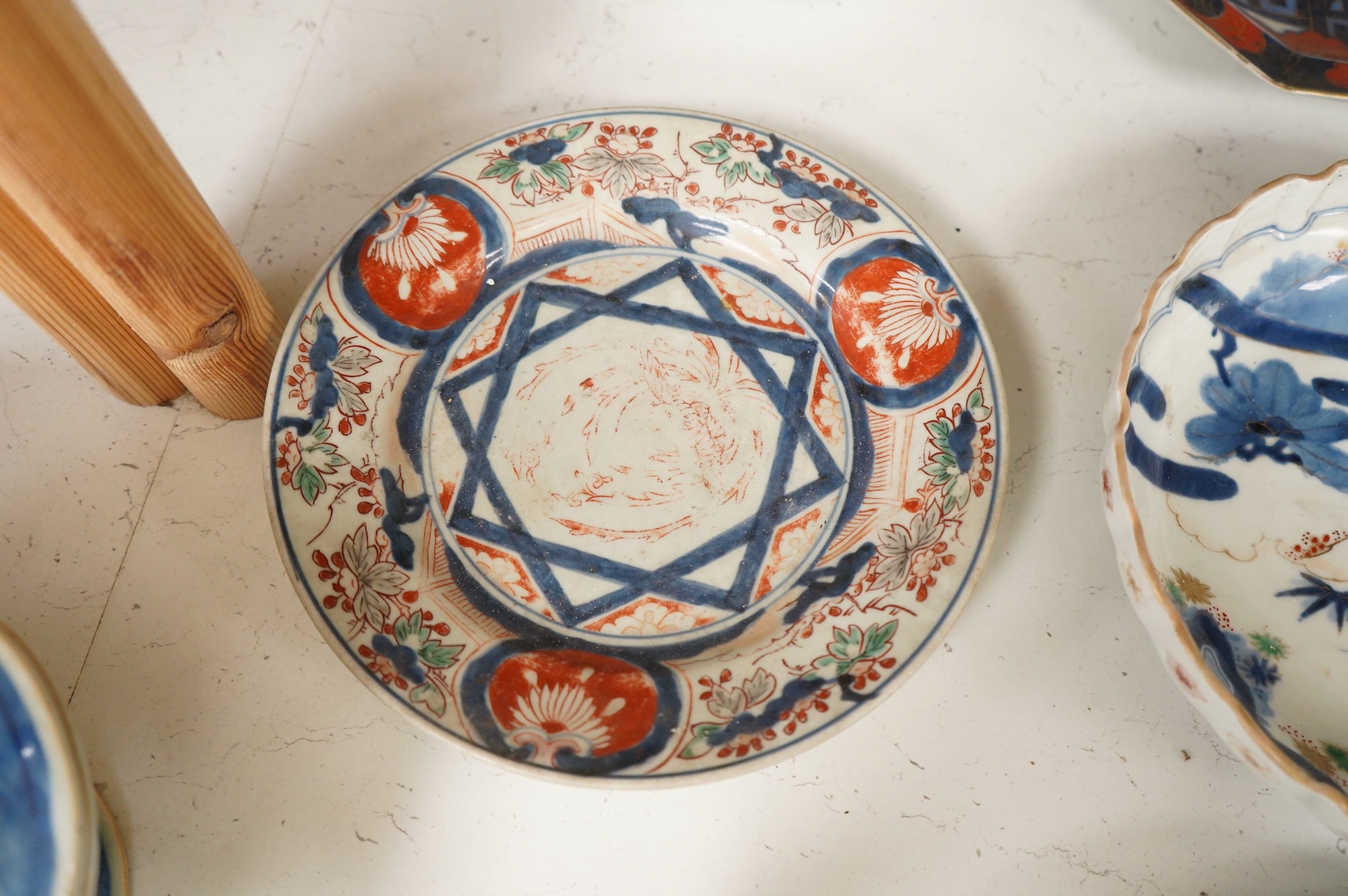 Six 19th century Japanese plates and a bowl, mostly Imari pattern, the octagonal dish with Koransha mark for Fukagawa, largest 24cm in diameter